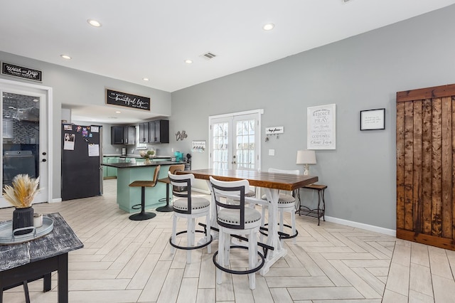 dining space featuring light parquet floors and french doors