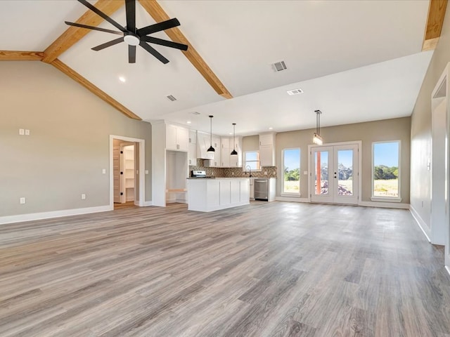 unfurnished living room with beam ceiling, ceiling fan, french doors, light hardwood / wood-style flooring, and high vaulted ceiling