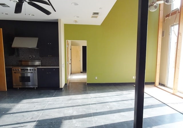 interior space with tasteful backsplash, ceiling fan, high end stainless steel range oven, and ventilation hood