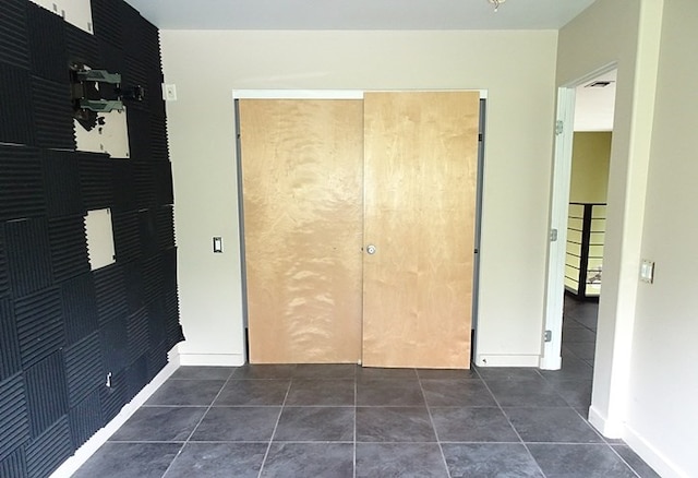 unfurnished bedroom featuring dark tile patterned floors