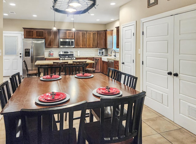 dining area with light tile patterned flooring, visible vents, and recessed lighting