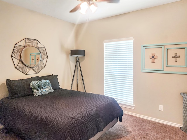 bedroom with ceiling fan, baseboards, and carpet floors