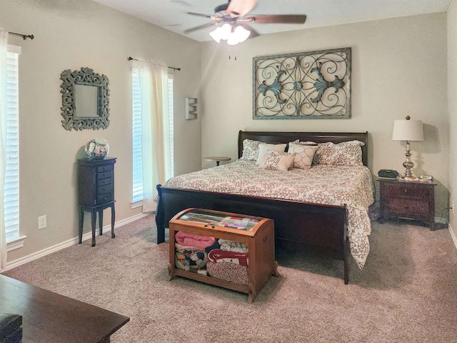 carpeted bedroom with ceiling fan and baseboards