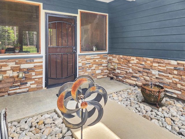 view of exterior entry featuring stone siding