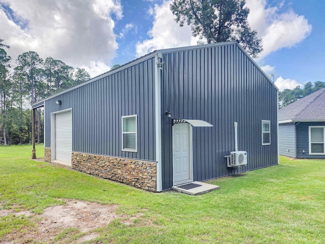 view of outbuilding featuring a garage and a yard