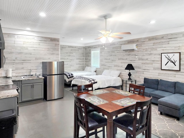 dining space with ceiling fan, a wall unit AC, recessed lighting, and finished concrete floors