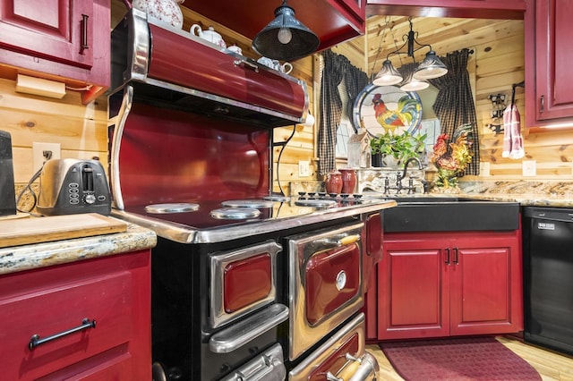 kitchen featuring black dishwasher, sink, decorative backsplash, and wood walls