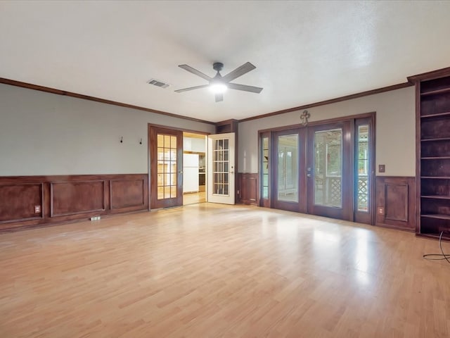 2524 US Highway 69 N, Lufkin, TX 75904 - unfurnished room featuring french doors, ornamental molding, a wainscoted wall, ceiling fan, and light wood-style floors