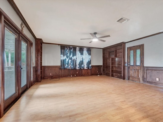 2524 US Highway 69 N, Lufkin, TX 75904 - empty room with ornamental molding, a wainscoted wall, light wood-style floors, french doors, and a ceiling fan