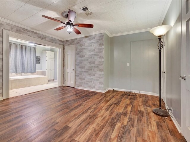 2524 US Highway 69 N, Lufkin, TX 75904 - empty room featuring a ceiling fan, wood finished floors, and crown molding