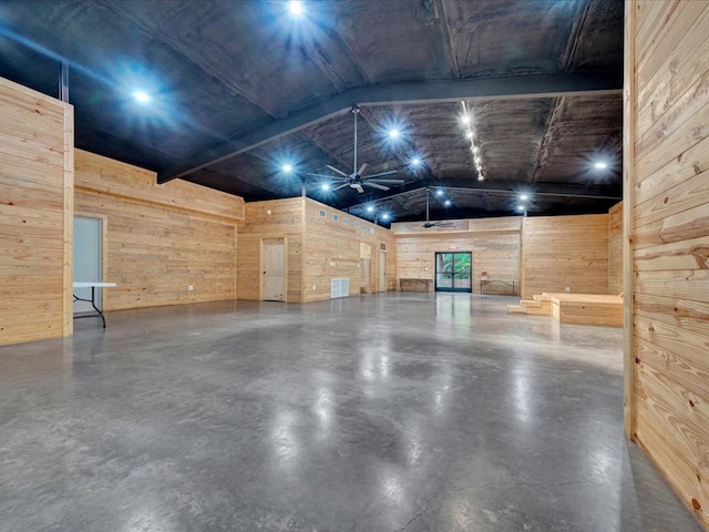 2524 US Highway 69 N, Lufkin, TX 75904 - miscellaneous room with wooden walls, lofted ceiling, finished concrete flooring, and ceiling fan