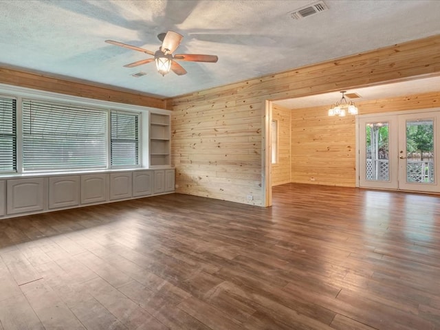 2524 US Highway 69 N, Lufkin, TX 75904 - unfurnished room with ceiling fan, a chandelier, wood walls, wood finished floors, and a textured ceiling