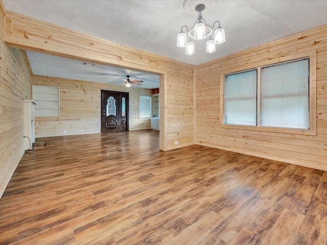 2524 US Highway 69 N, Lufkin, TX 75904 - empty room featuring wooden walls, wood finished floors, a chandelier, and a ceiling fan