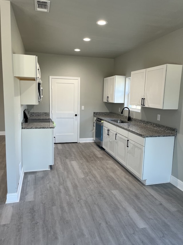 kitchen with white cabinets, appliances with stainless steel finishes, and sink