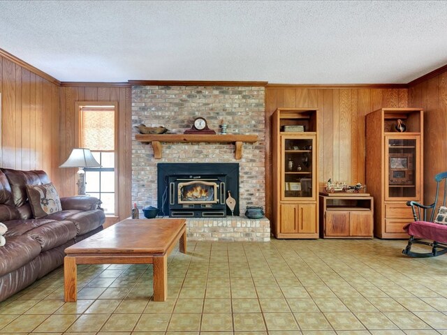 tiled living room featuring a wood stove, wooden walls, built in shelves, and a textured ceiling