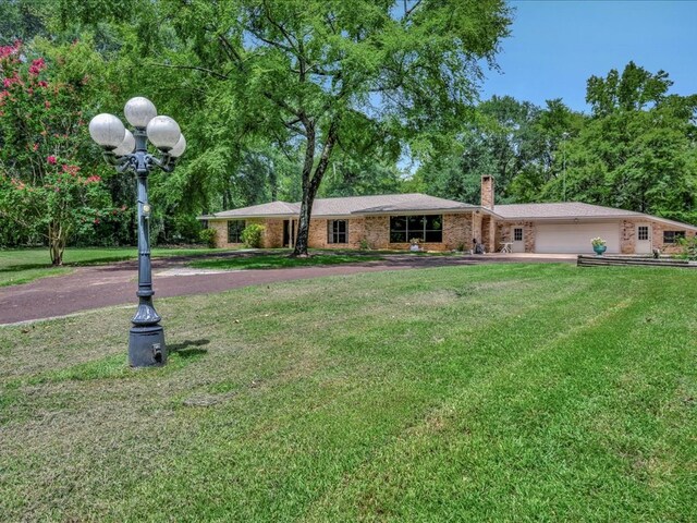 view of front of house featuring a garage and a front lawn