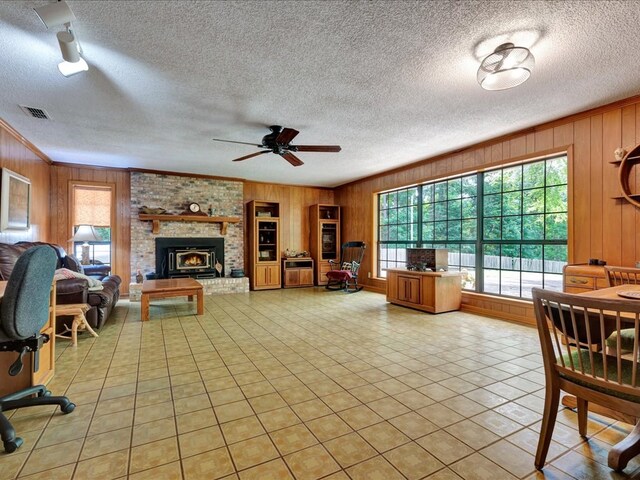 tiled living room with a textured ceiling and wooden walls