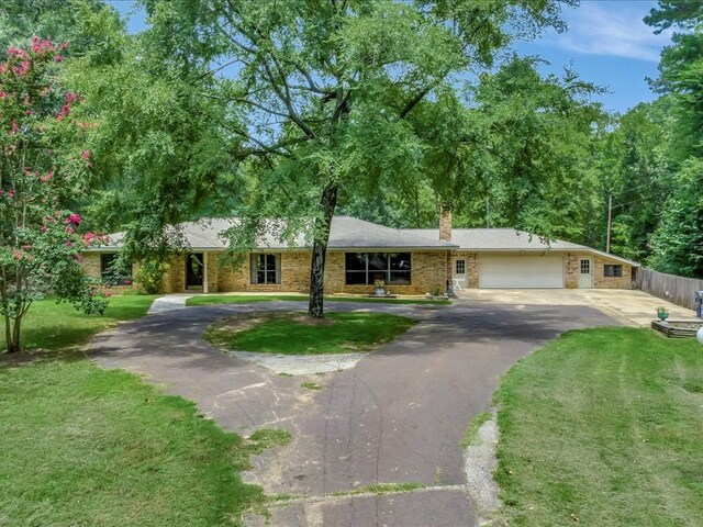 ranch-style house with a front yard and a garage