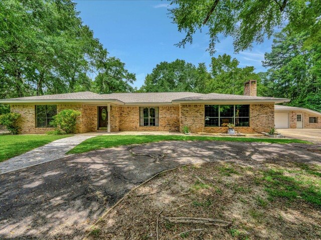 ranch-style house with a front yard and a garage