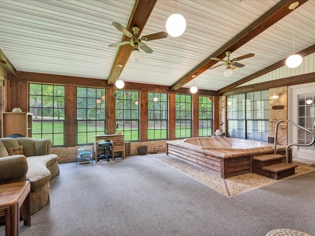 sunroom with ceiling fan and lofted ceiling with beams