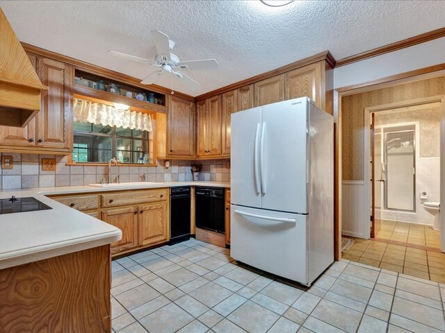 kitchen with decorative backsplash, ceiling fan, sink, black appliances, and light tile patterned floors