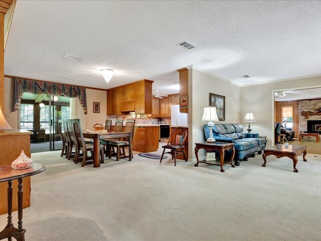 living room featuring light carpet, crown molding, a textured ceiling, and a brick fireplace