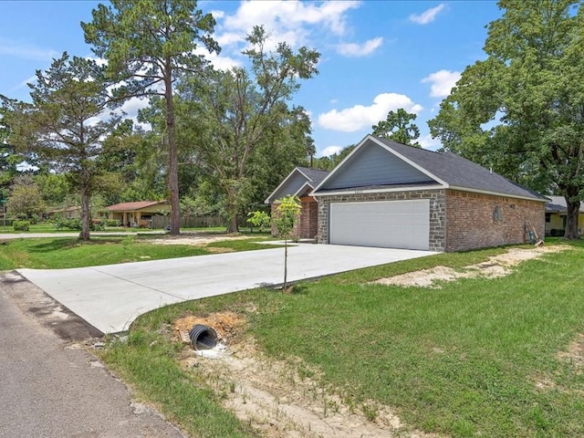 view of front of property with a front yard and a garage