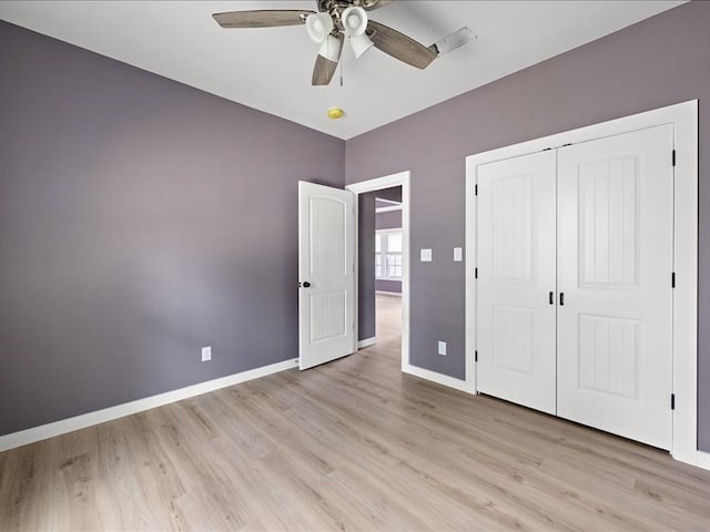 unfurnished bedroom with ceiling fan, light hardwood / wood-style floors, and a closet