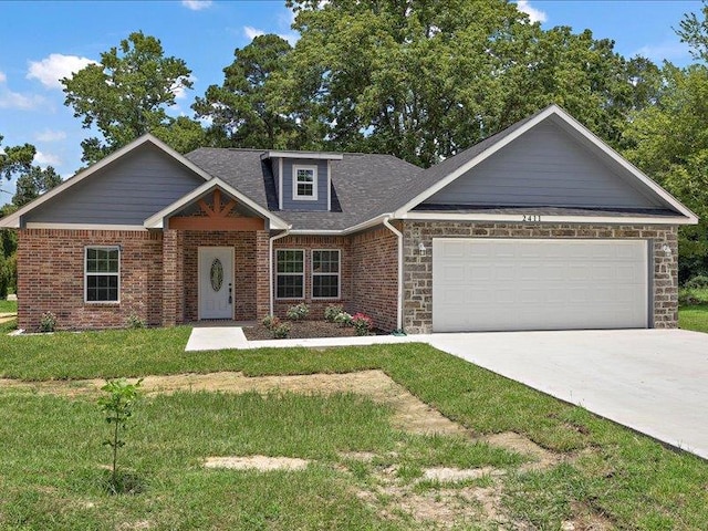 craftsman house with a front yard and a garage