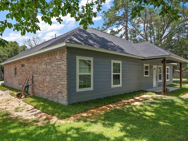 view of property exterior featuring a lawn and a patio