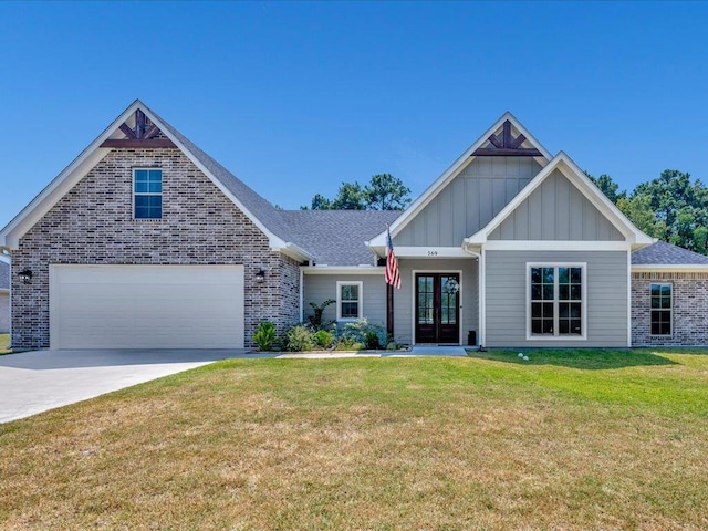 view of front facade with french doors, a front lawn, and a garage