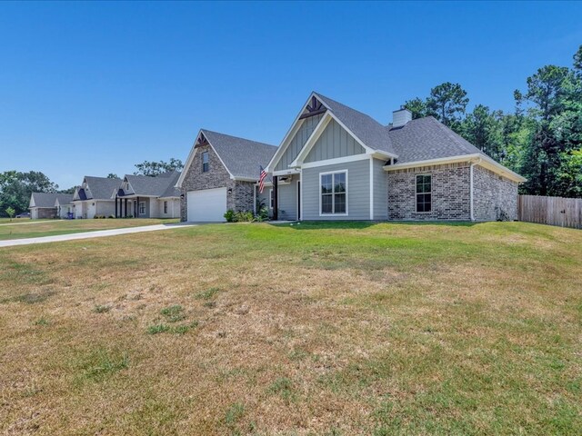 view of front facade featuring a garage and a front lawn