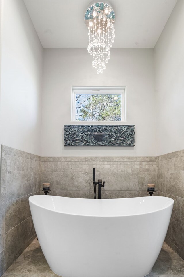 373 Duffer Dr, Brookeland, TX 75931 - full bathroom with tile walls, a soaking tub, and a wainscoted wall