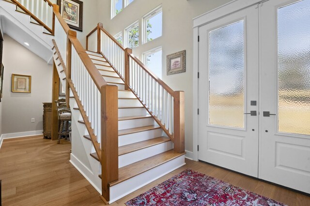 373 Duffer Dr, Brookeland, TX 75931 - foyer with stairway, wood finished floors, french doors, baseboards, and a towering ceiling