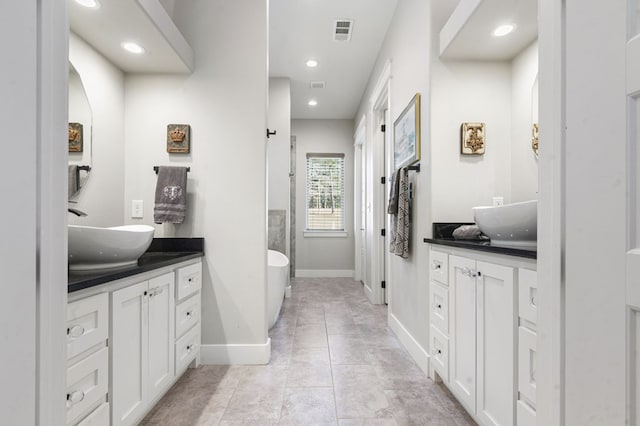 373 Duffer Dr, Brookeland, TX 75931 - full bath with vanity, a freestanding bath, baseboards, tile patterned floors, and recessed lighting