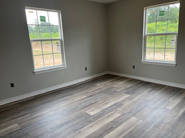 unfurnished room featuring wood finished floors and baseboards