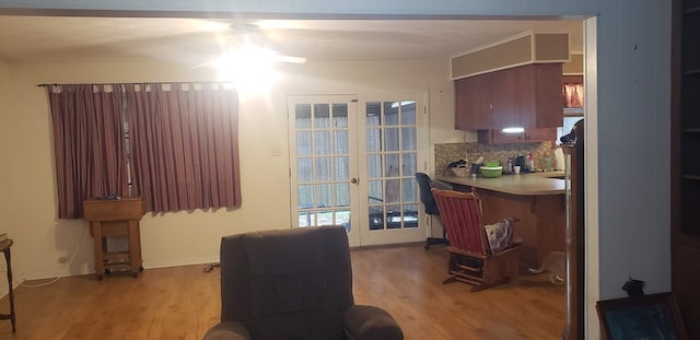 interior space featuring decorative backsplash, french doors, and light hardwood / wood-style floors