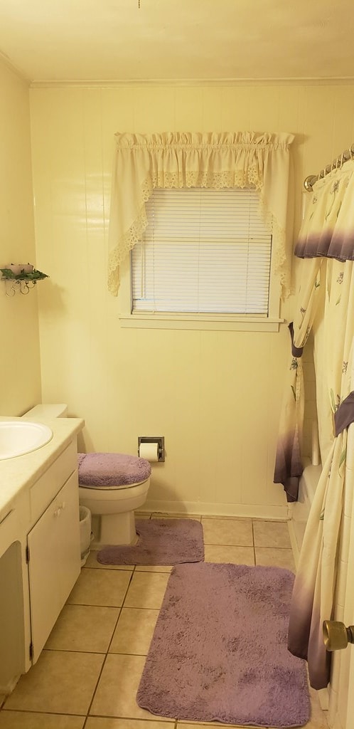 bathroom with tile patterned flooring, vanity, and toilet