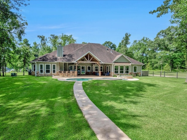 410 Brentwood Dr, Lufkin, TX 75901 - rear view of house with a patio, an outdoor pool, and a chimney
