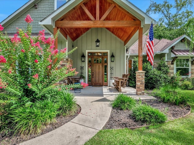 410 Brentwood Dr, Lufkin, TX 75901 - view of exterior entry featuring board and batten siding, a porch, and stone siding