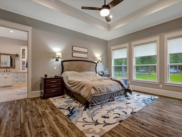 410 Brentwood Dr, Lufkin, TX 75901 - bedroom featuring wood finished floors, multiple windows, ornamental molding, ensuite bath, and a tray ceiling