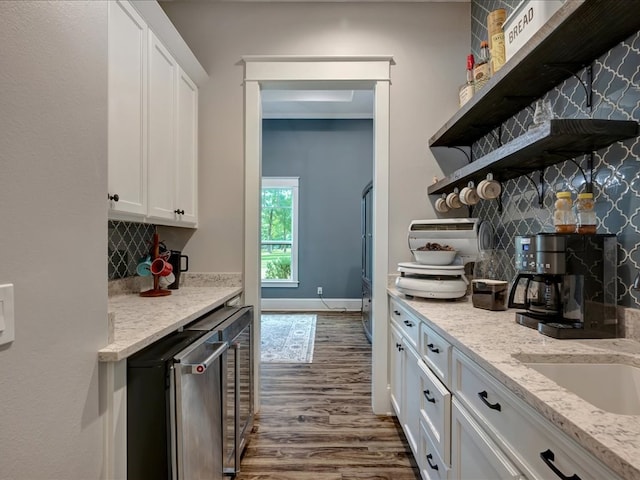 410 Brentwood Dr, Lufkin, TX 75901 - kitchen featuring open shelves, white cabinetry, dark wood finished floors, decorative backsplash, and light stone counters