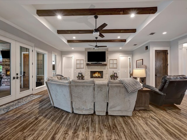 410 Brentwood Dr, Lufkin, TX 75901 - living area with wood finished floors, a fireplace, beam ceiling, a ceiling fan, and french doors