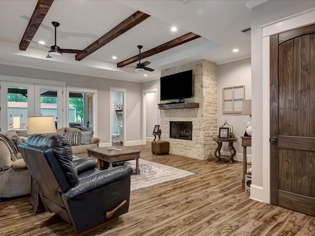 410 Brentwood Dr, Lufkin, TX 75901 - living area featuring a ceiling fan, a stone fireplace, wood finished floors, beamed ceiling, and recessed lighting
