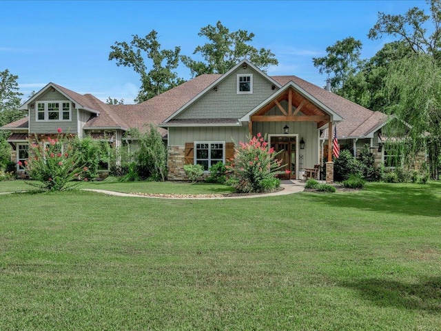 410 Brentwood Dr, Lufkin, TX 75901 - craftsman-style home with board and batten siding, a front yard, and stone siding