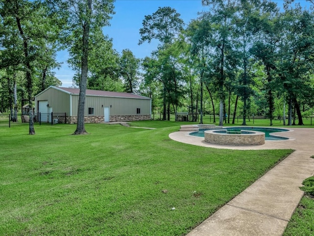 410 Brentwood Dr, Lufkin, TX 75901 - view of yard with a garage, a pool with connected hot tub, an outbuilding, and view of wooded area