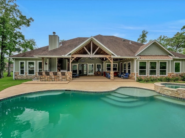 410 Brentwood Dr, Lufkin, TX 75901 - rear view of property featuring stone siding, a chimney, a ceiling fan, a patio, and board and batten siding