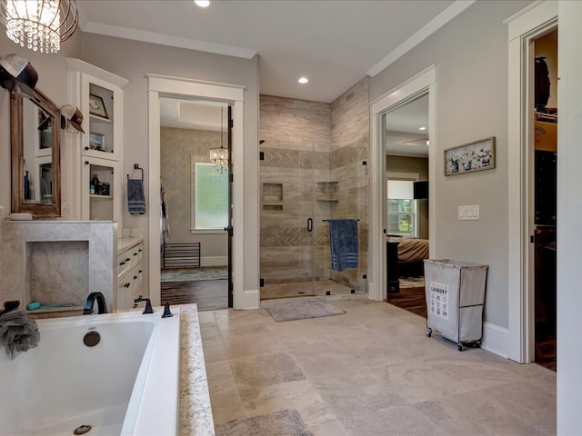 410 Brentwood Dr, Lufkin, TX 75901 - bathroom featuring a chandelier, a shower stall, vanity, crown molding, and a garden tub