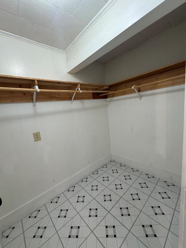 walk in closet featuring light tile patterned flooring