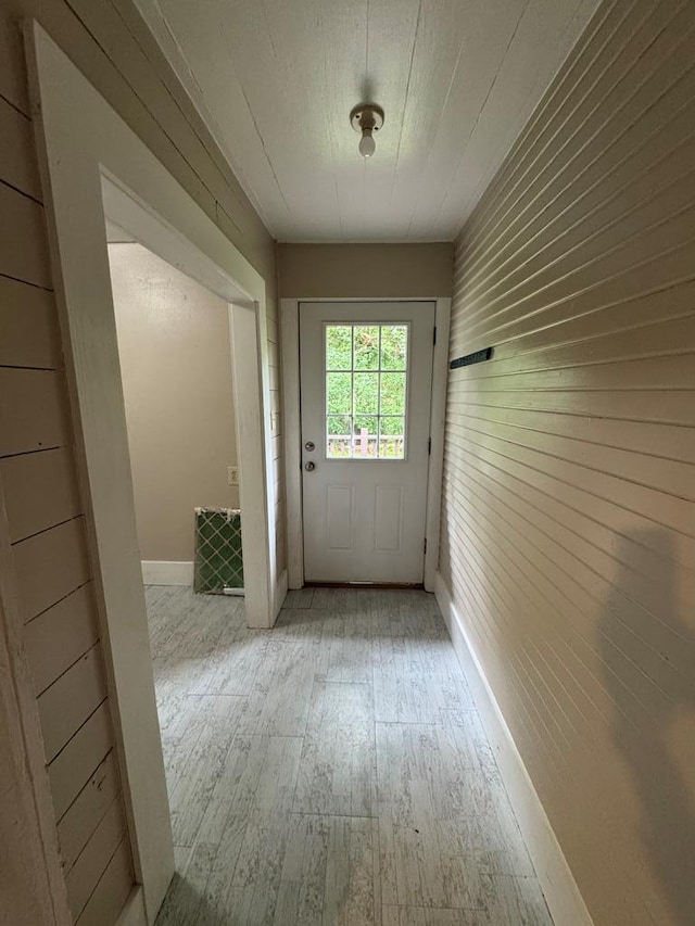 doorway to outside with wood-type flooring